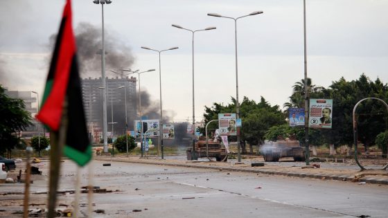 In this Wednesday, Oct. 29, 2014 photo, smoke rises during clashes between the Libyan military and Islamic militias in Benghazi, Libya. Government troops entered central Benghazi Wednesday after nearly 10 days of fighting Islamic extremist militias, a military spokesman said, in violence that killed dozens of people and forced hundreds of families to flee. (AP Photo/Mohammed El-Sheikhy)